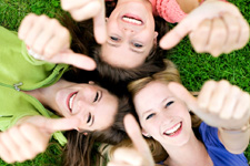 Smiling women giving a thumbs up